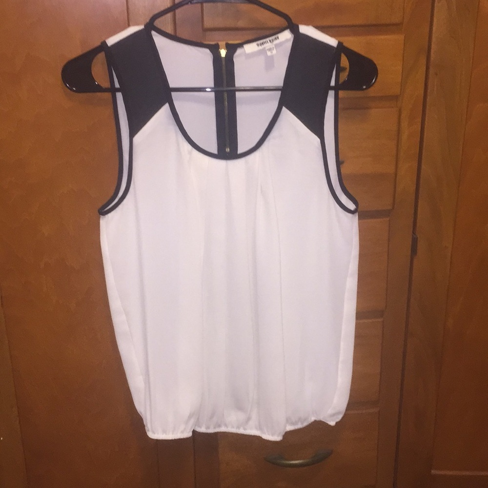 Cream colored tank with faux leather accents.